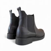 Δερμάτινα μποτάκια chelsea σε μαύρο χρώμα με λάστιχα στην εσωτερική και εξωτερική πλευρά με στρογγυλή μύτη πίσω όψη σε λευκό φόντο.